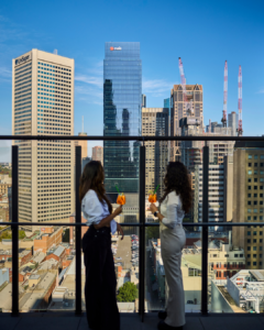 2 girls on a balcony celebrating