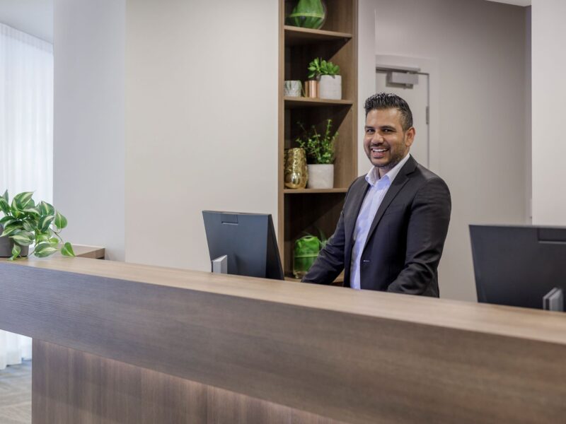 Hotel executive at the Brady Hotels reception desk welcoming guests