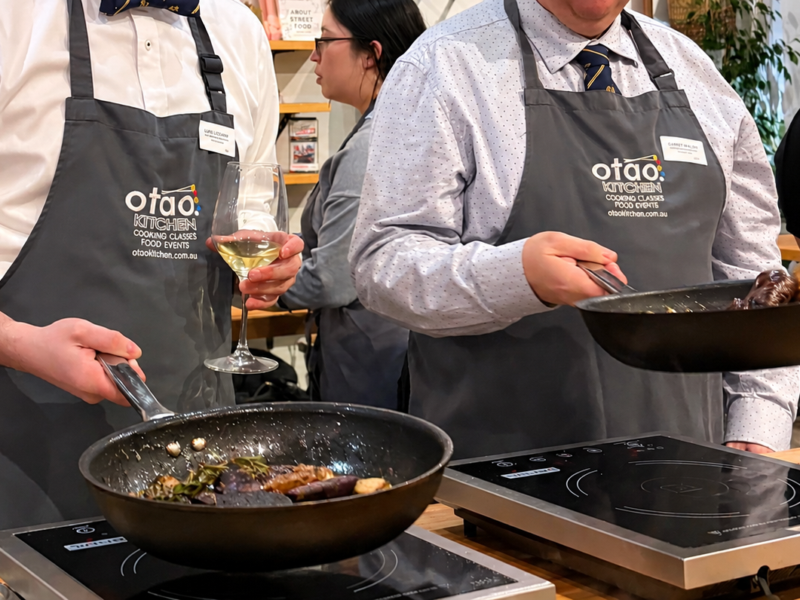 Guests enjoying a hands-on cooking class at Otao Kitchen in Melbourne